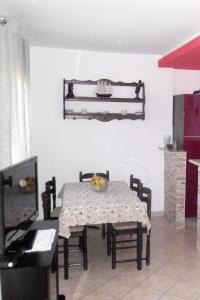 a dining room with a table and chairs and a piano at Apartments by the sea Splitska, Brac - 2923 in Postira