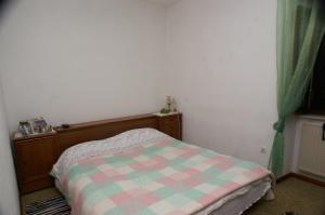 a small bedroom with a bed with a checkered blanket at Apartments by the sea Sutivan, Brac - 2946 in Sutivan