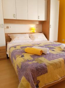 a bedroom with a bed with a yellow and purple blanket at Apartments with a parking space Bol, Brac - 2890 in Bol