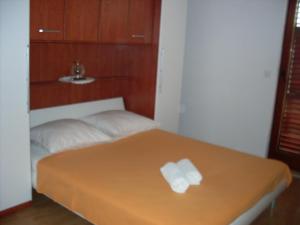 a bed with two rolls of toilet paper on it at Apartments with a parking space Bol, Brac - 2890 in Bol