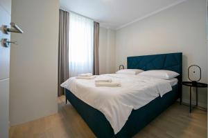 1 dormitorio con 1 cama grande y toallas. en NEW!! High end 2bd modern apartment in Novi Zagreb en Zagreb