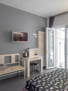 a bedroom with a bed and a desk and a desk at Minimal Chic in Verona