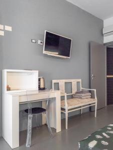 a desk with a computer on a wall with a chair at Minimal Chic in Verona