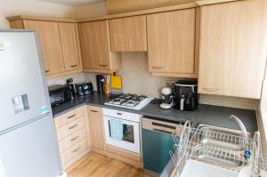 a kitchen with wooden cabinets and a stove top oven at Resource Homes in Bradshaw