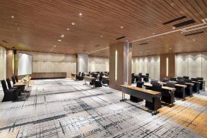 a large conference room with desks and chairs at Hotel Aruss Semarang in Semarang