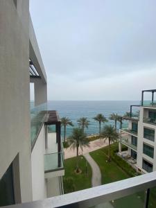 a view of the ocean from the balcony of a building at Two Bedroom Apartment Address Residence - Fujairah in Fujairah