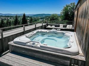 a hot tub sitting on top of a balcony at Vinica Castle in Vinica