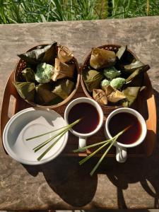 dwie miski jedzenia i dwie miski sosu do kąpieli. w obiekcie Batan Nyuh Retreat w mieście Gianyar