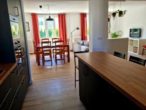 a kitchen and living room with a table and chairs at Appartement Cosy Caen in Caen