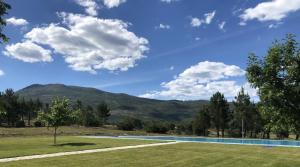 a swimming pool with a mountain in the background at Casa da Pipela in Santo André