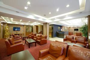 a lobby with leather chairs and a waiting room at Grand Unal Hotel in Istanbul