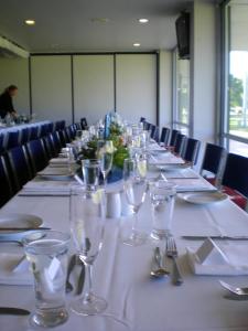 a long table with glasses and napkins on it at Christchurch Park Motel in Christchurch