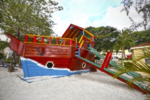 a playground with a slide in the sand at Simpson Bay Resort Marina & Spa in Simpson Bay