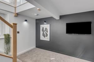 a living room with a flat screen tv on a wall at Unique apartment with parking / sofa bed in Norwich