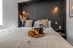 a tray of bread and croissants on a bed at Unique apartment with parking / sofa bed in Norwich