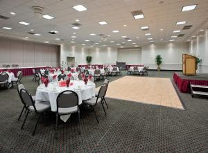 a banquet hall with tables and chairs in a room at Holiday Inn Redding by IHG in Redding +37 photos