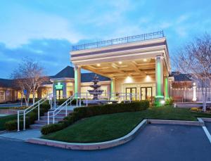 a large building with a staircase in front of it at Holiday Inn Redding by IHG in Redding