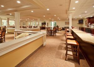 a restaurant with tables and chairs and a bar at Holiday Inn Redding, an IHG Hotel in Redding