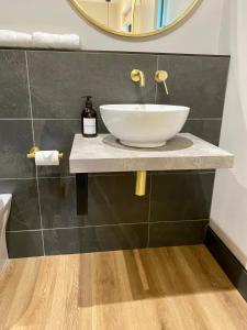 a bathroom with a sink and a mirror at Hygge at Vallum in Newcastle upon Tyne