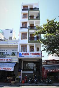 a tall white building with a sign on it at Thien Truong Hotel in Nha Trang