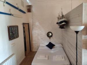 a small room with a bed and a lamp at Casa de pescadores in Llança
