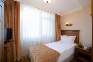 Un ou plusieurs lits dans un hébergement de l'établissement Grand Unal Hotel