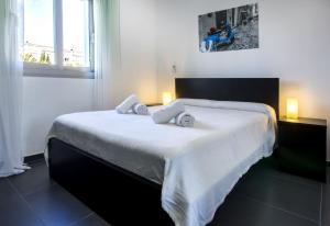 a bedroom with a large white bed with two pillows at Villa Vallesa Calpe in Ifach +19 photos