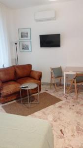 a living room with a couch and a table at Casa RA in Bari