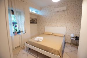 a bedroom with a bed with two towels on it at DONNA ROSITA in San Felice a Cancello
