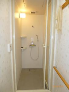 a bathroom with a shower in a room at Hotel Diamond in Osaka