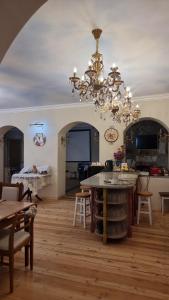 a large living room with a chandelier at Amrots Deghceni - Boutique Castle Stay in Dilijan
