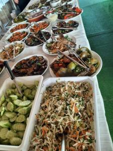 a table with many different dishes of food on it at Hotel Sapphire in Primorsko