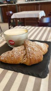 two pieces of bread on a table with a bowl of soup at 285 Vatican Lodge in Rome