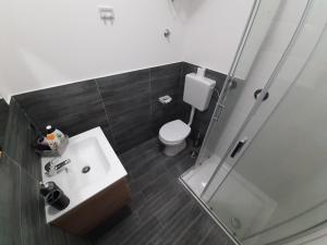 a bathroom with a toilet and a sink and a shower at DONNA ROSITA in San Felice a Cancello +37 photos