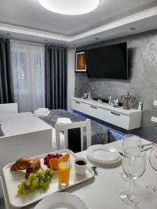 a room with a table with a tray of food on it at Studio DeLux in Giurgiu