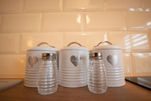 a group of four water bottles sitting on a table at Stobhan Apartment in Fort William