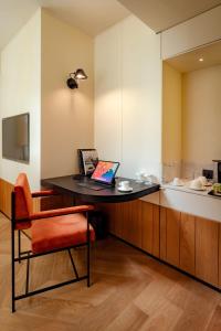 a desk in a room with a laptop on it at The Gift Hotel in Istanbul