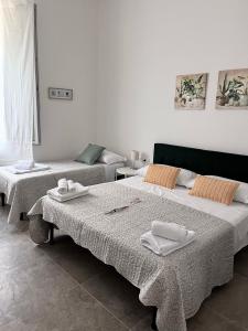 a bedroom with two beds and a couch at CapoDiLucca40 in Bologna