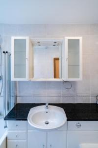 a bathroom with a sink and a mirror at (St' Paul Cathedral) London Studio Apartment in London