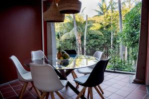 a dining room with a glass table and chairs at Villa 202 in Port Louis