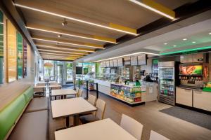 a fast food restaurant with tables and a counter at Days Inn by Wyndham Miami Airport North in Miami
