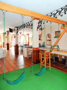 a swing set in the living room of a house at Hotel Zihua Caracol in Zihuatanejo