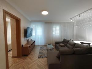 a living room with a couch and a table at Decebal Premium Confort in Craiova