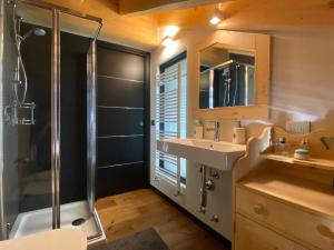 a bathroom with a sink and a shower at Chalet Ronchi - Foppolo Ski in Foppolo