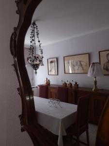 a dining room with a table and a chandelier at VELOCIPEDE OUDENAARDE vakantieverblijf 6 pers in Oudenaarde