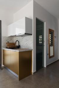 a kitchen with a sink and a counter top at SKYROS BLUE SUITES in Skiros