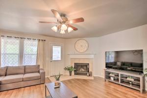 a living room with a ceiling fan and a flat screen tv at Family Getaway with Pool Access, Near SeaWorld! in San Antonio