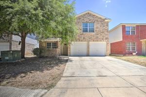 a large brick house with two garage doors at Family Getaway with Pool Access, Near SeaWorld! in San Antonio