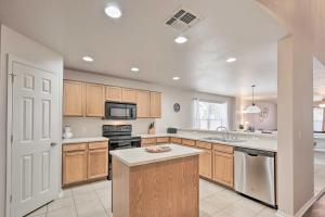 a kitchen with wooden cabinets and a stove top oven at Family Getaway with Pool Access, Near SeaWorld! in San Antonio
