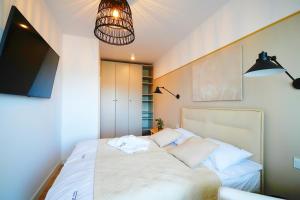 Postel nebo postele na pokoji v ubytování Apartments AQUA & SPA